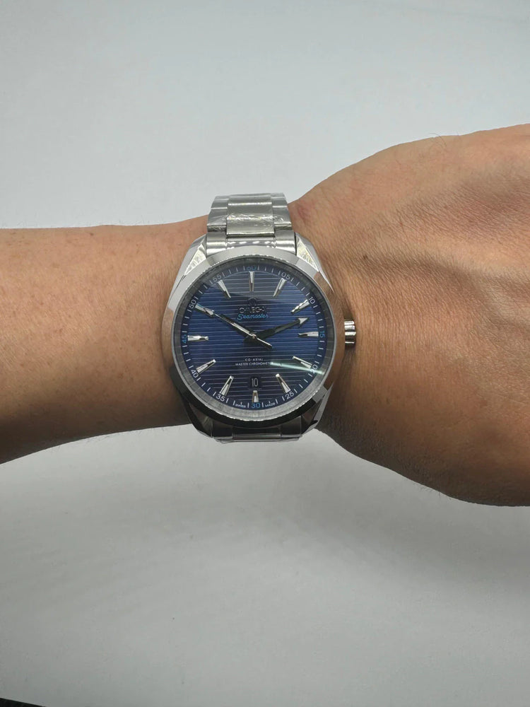 Relógio automático com mostrador azul e pulseira metálica no pulso