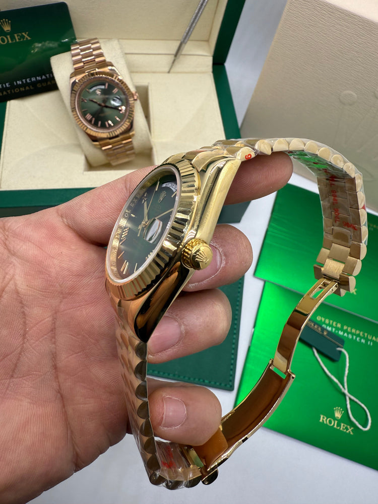 Relógio Rolex dourado visto de lado, pulseira metálica e mostrador verde.