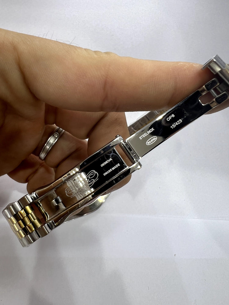 Relógio bicolor com pulseira metálica e fundo com marcações na lateral