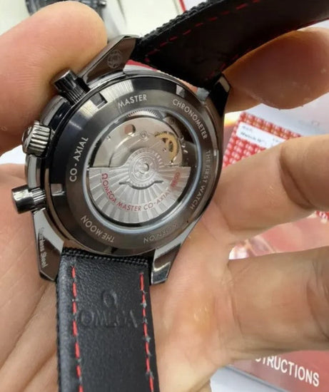 Relógio Omega com tampa traseira metálica e pulseira de couro preta com costura amarela