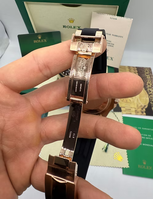 Relógio Rolex com caixa em ouro rosé e pulseira preta, mostrando o verso